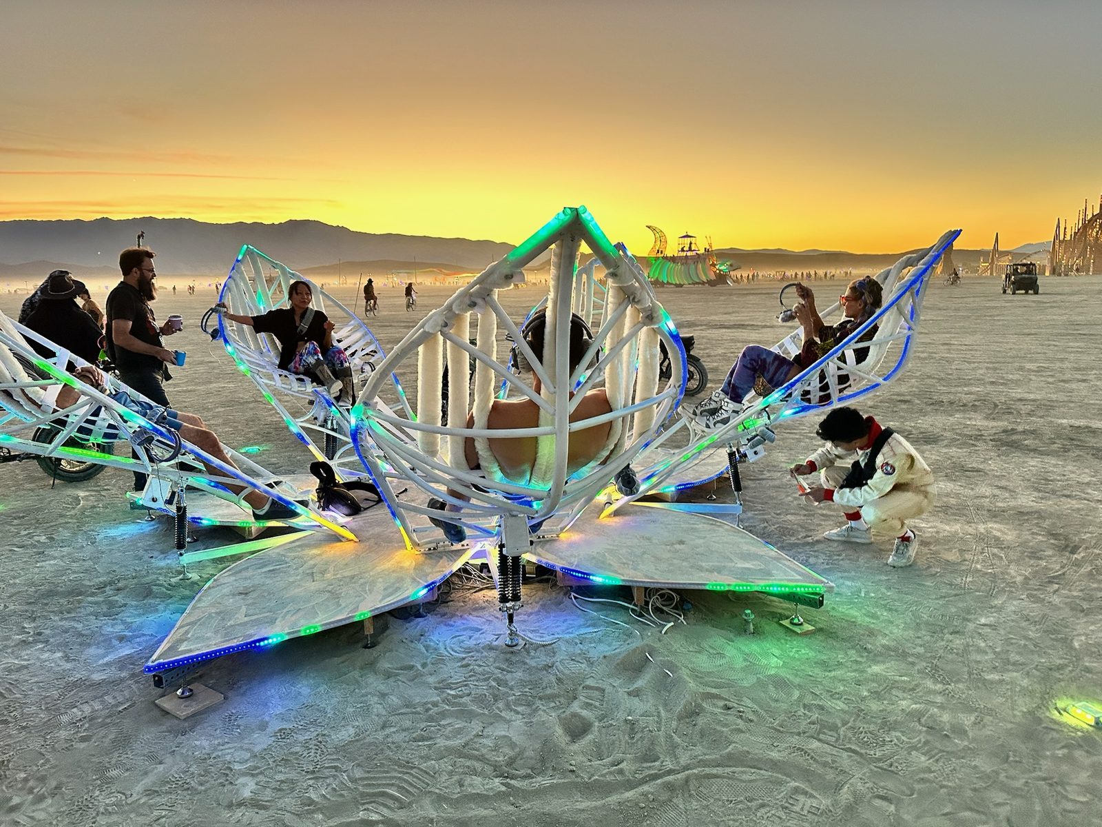 Participants sharing the reclining petals of Hortus Lux on the playa